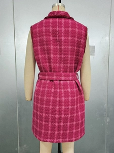Detail of fuchsia plaid sleeveless vest featuring tweed texture and waist belt