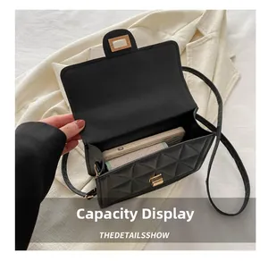 Interior view of black quilted crossbody bag showing space for phone and small wallet