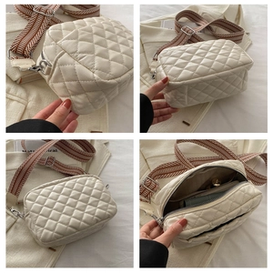 Detail view of beige quilted crossbody bag with stylish geometric wide strap