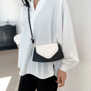 Chic black and white contrast crossbody bag with heart detail and chain strap for women