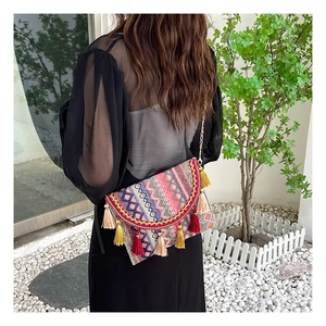 Ethnic style crossbody bag with colorful woven patterns and vibrant long tassels