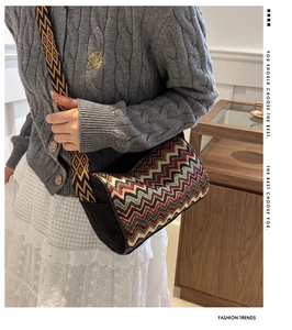 Bohemian barrel crossbody bag with vibrant zigzag patterns and wide ethnic strap