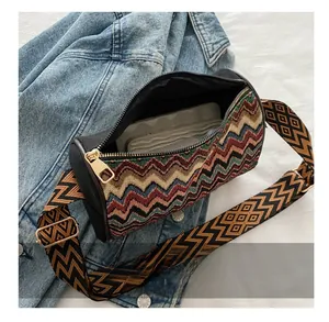 Top view of woven cylinder crossbody bag showing spacious interior with colorful wave patterns