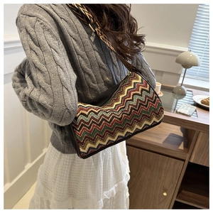 Close-up of ethnic colorful zigzag pattern fabric on a stylish crossbody shoulder bag