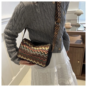 Close-up of a bohemian wave pattern crossbody bag with wide jacquard shoulder strap