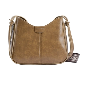 Vintage brown leather shoulder bag with ethnic style wide strap and curved retro design