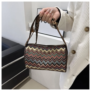 Close-up of bohemian bucket bag with vibrant woven zigzag pattern and wide jacquard strap