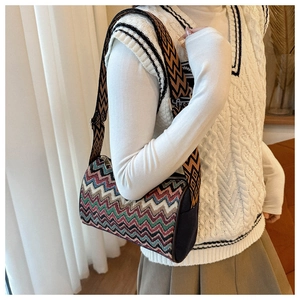 Detail of colorful zigzag jacquard barrel bag with adjustable geometric wide shoulder strap