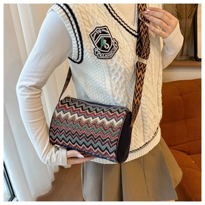 Detailed shot of multi-colored chevron knit crossbody bag with a wide patterned shoulder strap