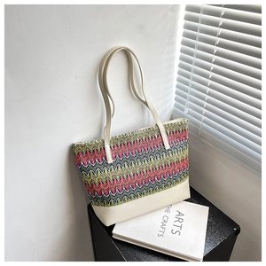 Fashionable woven patchwork tote bag with colorful pattern and cream leather shoulder strap