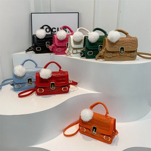 Mini crocodile pattern crossbody bag with golden clasp and furry pompom charm