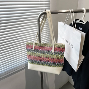 Handwoven wave pattern straw tote bag with colorful zigzag design and leather handles