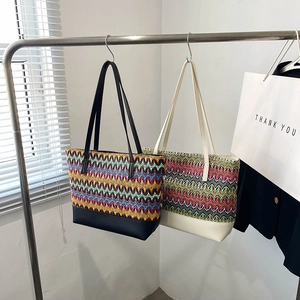 Stylish woven tote bag with wavy patterns and leather handles for women's daily commute