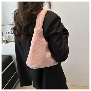 Chic pink faux fur tote bag styled with a black blazer for a trendy winter aesthetic