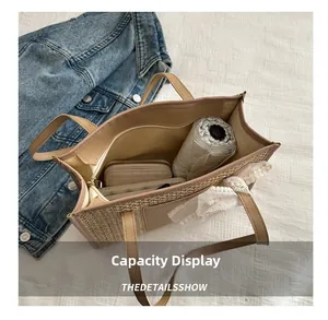 Straw tote bag capacity display showing folded umbrella and wallet with lace bow detail