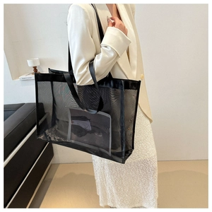 Close-up of black mesh tote bag showing breathable texture and durable woven handle