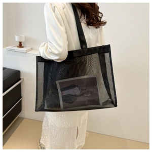Close-up of black mesh tote bag showing large capacity and semi-transparent texture