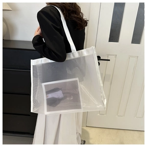 Detail shot of the breathable white mesh tote bag with wide durable shoulder straps
