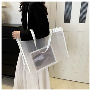 Side view of a white mesh tote bag with magazine detail, showing large capacity and mesh texture