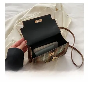 Interior view of plaid tweed handbag showing capacity for phone and wallet