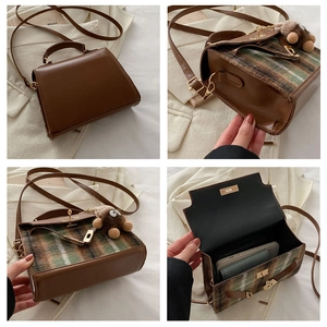 Detail view of plaid retro handbag with vintage metal lock and brown plush monster charm