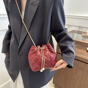 Chic burgundy quilted bucket bag with gold chain and pearl drawstring for women