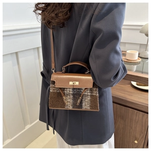 Classic checkered plaid handbag with leather strap shown in a stylish lifestyle setting