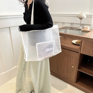 Minimalist white mesh tote bag with shoulder straps for women shown in a casual lifestyle setting