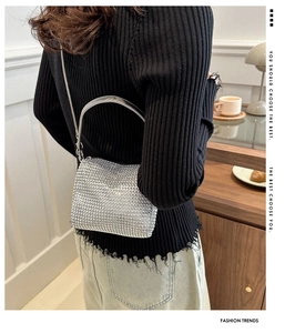 Detail of silver rhinestone mini bag showing the metal handle and crossbody chain