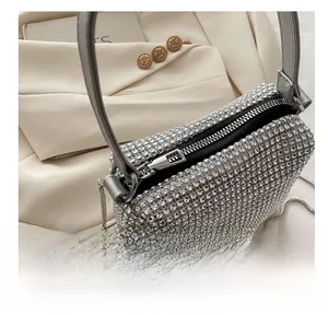 Close-up of smooth metal zipper and silver rhinestone mesh on evening handbag