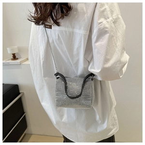 Silver rhinestone handbag styled as a crossbody bag with a white shirt and chain strap