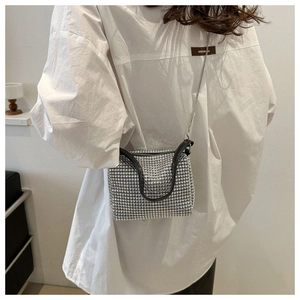 Silver rhinestone crossbody bag with metal chain strap worn on white oversized shirt