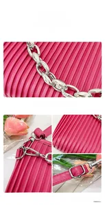 Detailed view of hot pink pleated handbag featuring silver chain and metal hardware