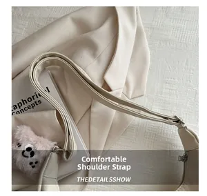 Detail view of the comfortable wide shoulder strap on a minimalist beige tote bag