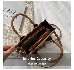 Internal capacity view of brown tote bag showing black lining and zip compartment