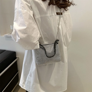 Elegant silver rhinestone shoulder bag with black leather trim and fine metal chain strap