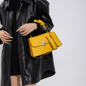 Yellow quilted shoulder bag with heart clasp and ruffled handle for women's fashion