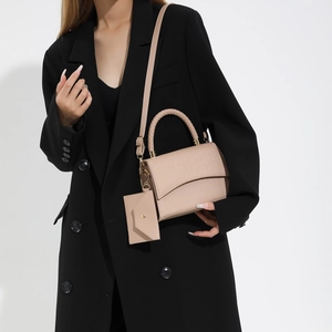 Minimalist beige crocodile embossed faux leather shoulder bag with a woven handle
