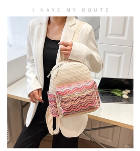 Side view of woven backpack with colorful wave patterns on white blazer model