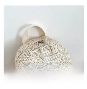 Close-up of woven crossbody bag showing smooth metal zippers and textured fabric detail