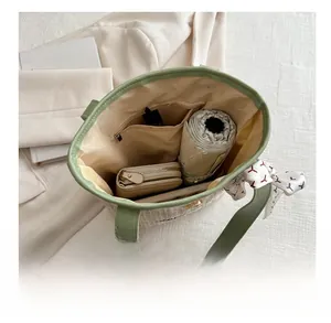 Interior view of straw tote bag showing large capacity for umbrella and cosmetics
