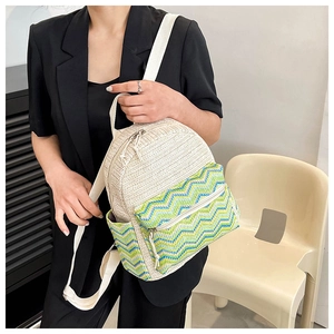 Ethnic woven backpack with chevron pattern shown on a model in a black blazer
