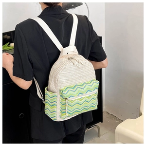 Detail of bohemian straw backpack featuring woven chevron pattern and colorful wavy stripes