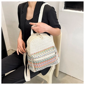 Close-up of woven backpack featuring colorful wave patterns and silver zipper detail