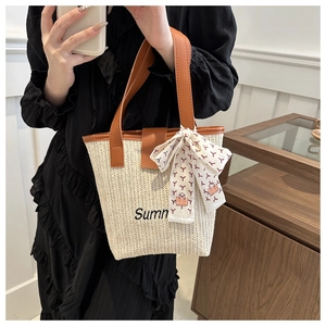 Detail of summer woven straw tote with silk scarf and embroidered Summer text