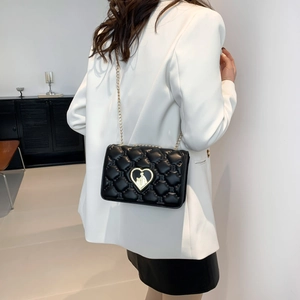 Minimalist black quilted crossbody bag with gold heart lock and letter embossing