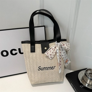 Large woven straw tote bag with black leather straps and Summer embroidery detailing