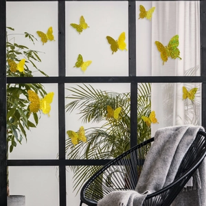Detailed view of yellow 3D glitter butterfly wall stickers on a modern black window frame
