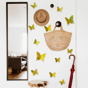 Detail of 3D gold glitter butterfly wall stickers on a modern entryway wall