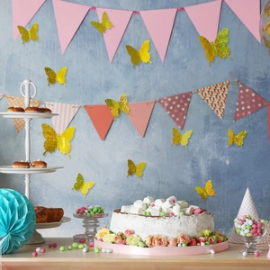 Close-up of golden glitter 3D butterfly wall stickers in a festive party setting